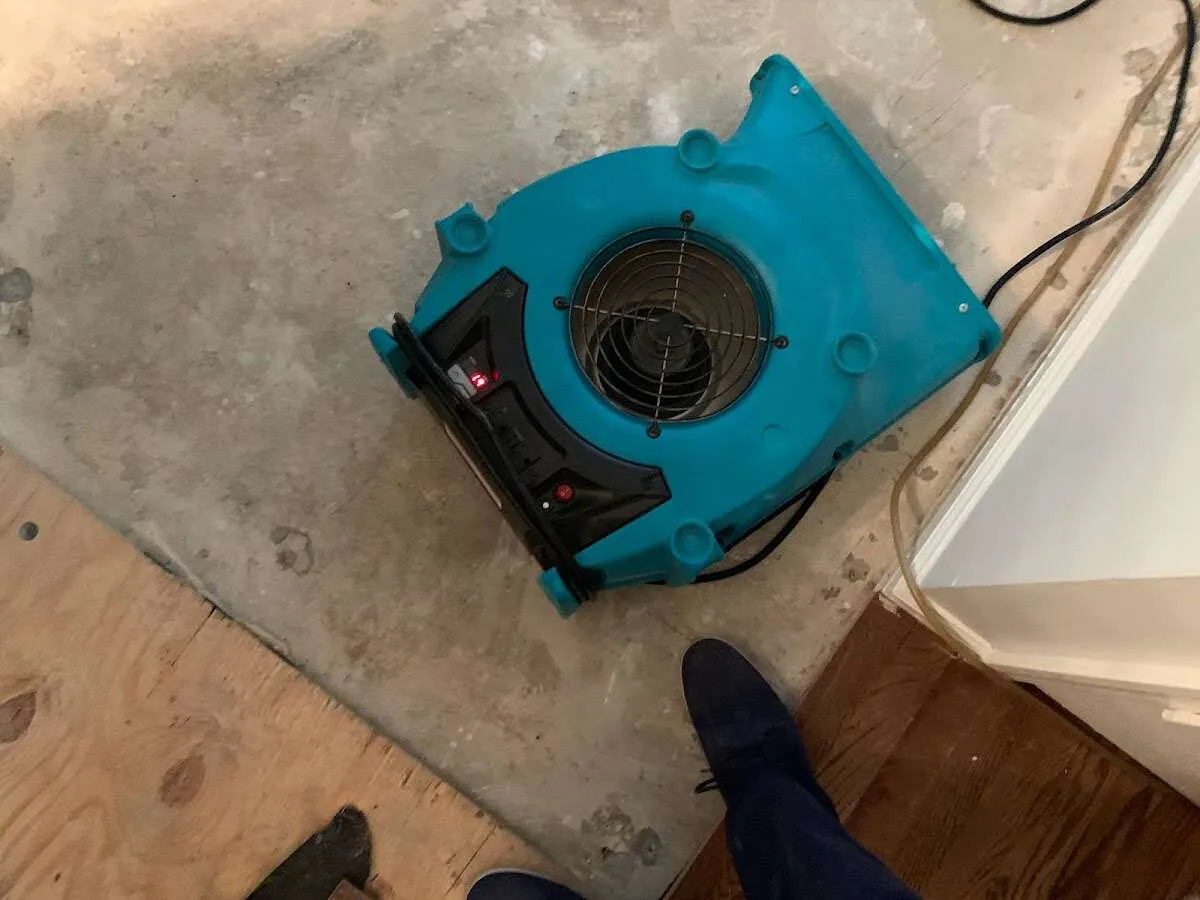 Air mover drying subfloor during Leak Detection & Repair in North Ogden